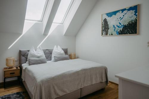 a bedroom with a bed and a painting on the wall at Fugger Alm in Weichselbaum