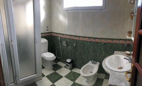 a bathroom with a toilet and a sink at GAMRA Villa in Agadir