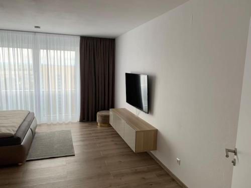 a living room with a television on a wall at Eine gemütliche Einzimmerwohnung in Ostfildern