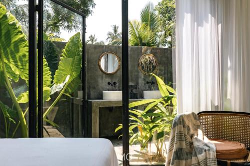 a room with a bed and a mirror on a balcony at Tao House Jungle Boutique Villas in Ahangama