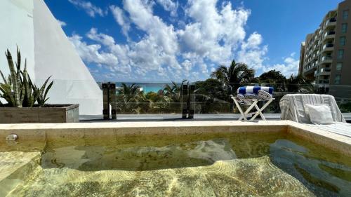 a swimming pool with a view of the ocean at Xcanan Loft On Park Royal, the best area in Cancún right on the beach in Cancún