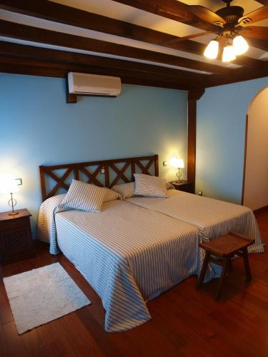 a bedroom with two beds and a ceiling at Hostal El Cerro - Only Adults in Pedro Bernardo