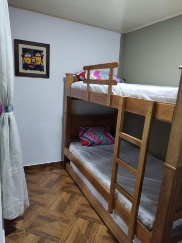 a room with two bunk beds and a ladder at APARTAMENTO BALCON DE LA ESPERANZA GUATAPE in Guatapé