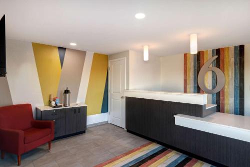 a waiting room with a red chair and colorful walls at Motel 6 Bonne Terre, MO in Bonne Terre