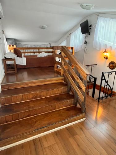 a bedroom with stairs leading up to a bunk bed at El Encanto del Manzano & Espacio Vittalia Spa in San José de Maipo