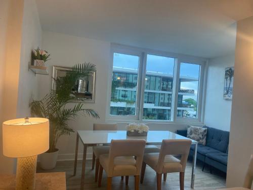 a living room with a table and chairs and a couch at Large 1 Bedroom apartment at Roney Palace Sleep 8 in Miami Beach