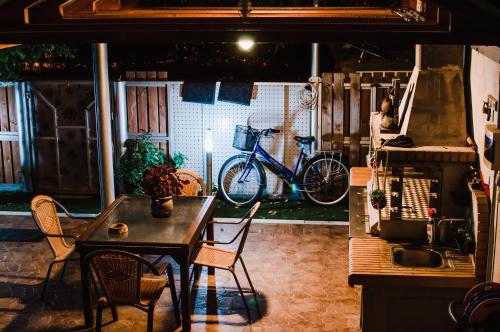 a kitchen with a table and chairs and a bike at g.home in Tríkala