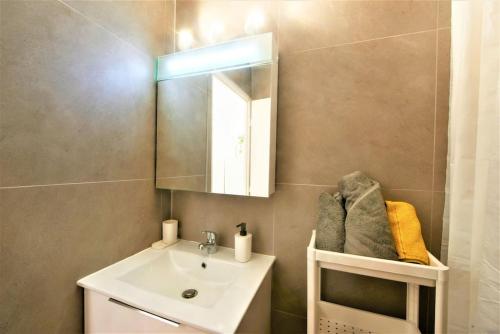 a bathroom with a sink and a mirror at EMbnb - Studio Near Geneva - S204,4 in Étrembières