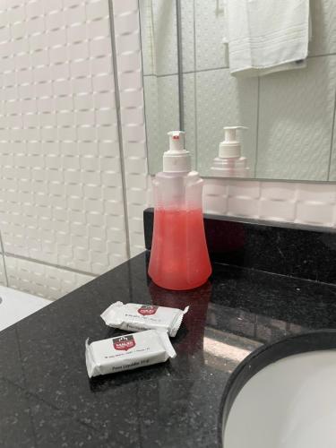 a bottle of mouthwash sitting on a counter in a bathroom at Mauri Center Hotel in Picos