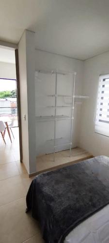 a bedroom with a bed in a room with a window at Apartasol Amor y Café, Reserva de la Colina in La Tebaida