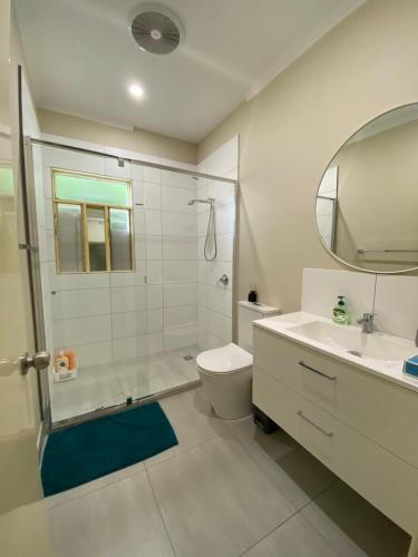 a bathroom with a shower and a toilet and a sink at Melbourne Mitcham Holiday Home in Mitcham