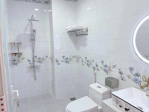 a white bathroom with a toilet and a sink at Le Phan Hotel in Tây Ninh