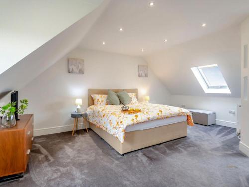 a attic bedroom with a bed and a skylight at Hill Crest in Dunston