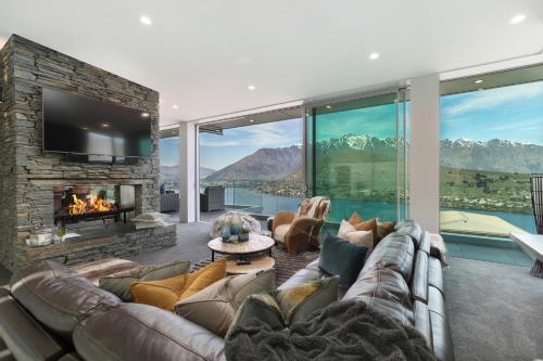 a living room with a couch and a fireplace at Remarkable Lake House in Queenstown