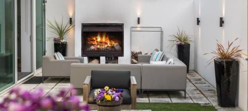 a living room with a couch and a fireplace at Remarkable Lake House in Queenstown