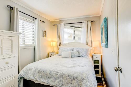 a small bedroom with a bed and two windows at HH Beach & Tennis 132C in Hilton Head Island