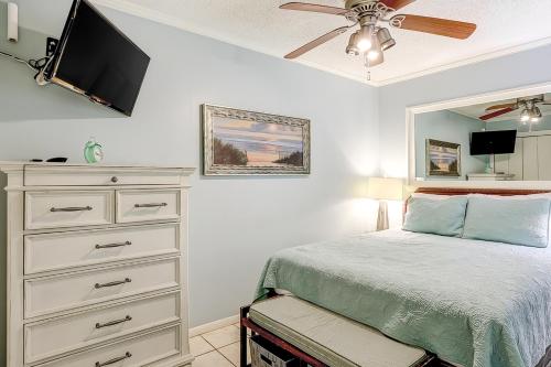 a bedroom with a bed and a dresser with a flat screen tv at HH Beach & Tennis 245B in Hilton Head Island
