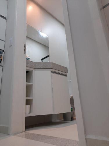 a kitchen with white cabinets in a room at FLATS TAVARES ARAUJO 202 in Garanhuns