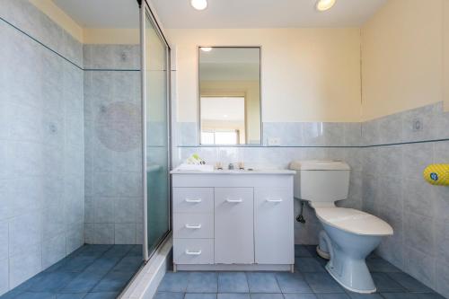 a bathroom with a toilet and a sink and a shower at 1 6 Convent Lane-LJHooker Yamba in Yamba