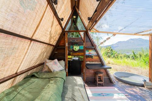 a room in a yurt with a bed and a tub at Cloud Hills Glamping by Bukit Vista in Kintamani