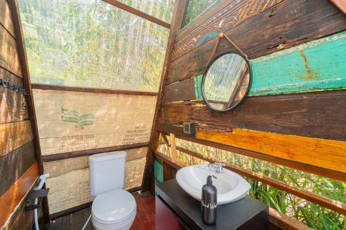 a bathroom with a toilet and a sink at Cloud Hills Glamping in Kintamani