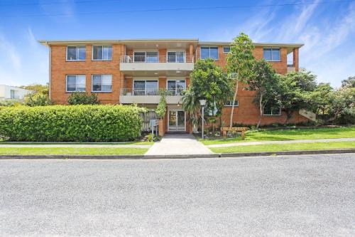 an empty street in front of a brick building at Seacrest 7 in Hawks Nest