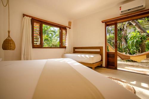 a bedroom with a bed and a window at Hurricane Jeri in Jericoacoara