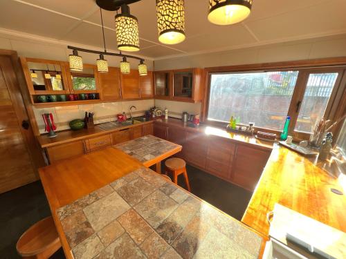 a kitchen with wooden cabinets and a counter top at Incredible Downtown Duplex with Interior Backyard in Punta Arenas