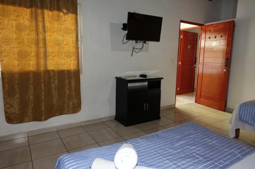 Un ou plusieurs lits dans un hébergement de l'établissement Hotel Posada Comala