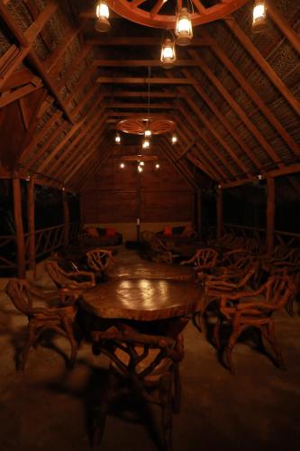 a large room with a wooden table and chairs at The Tottam Beach Hotel - Trincomalee in Trincomalee