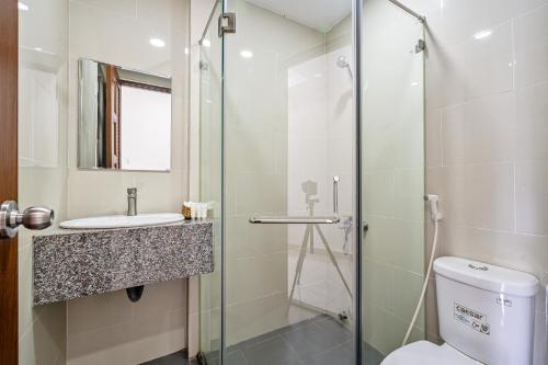 a bathroom with a shower and a toilet and a sink at AVIVA RESIDENCES in Thuan An