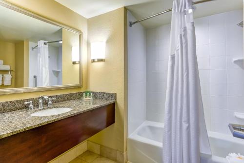 a bathroom with a sink and a shower at Holiday Inn Indianapolis North-Carmel by IHG in Carmel