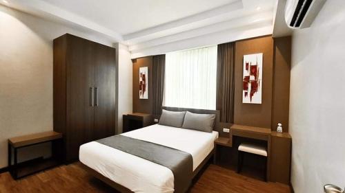 a bedroom with a large bed in a room at 2-3Bedroom Unit at The Padgett Place Condominium in Tabok
