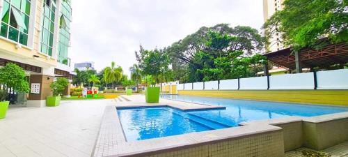 a swimming pool in the middle of a building at 2-3Bedroom Unit at The Padgett Place Condominium in Tabok
