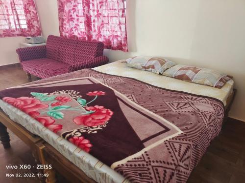 1 cama con manta y silla en una habitación en HisGrace BEACH COTTAGES - Private Beach at MALPE, en Udupi