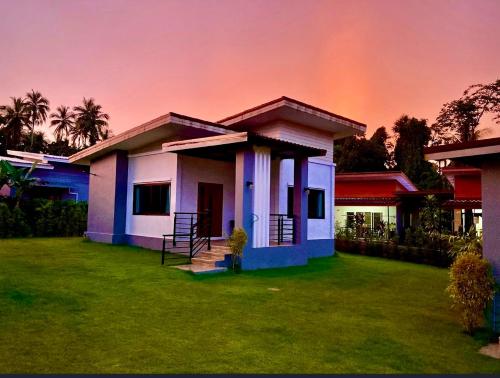 a house with a rainbow in the sky at KhaoLak Chill Out in Khao Lak
