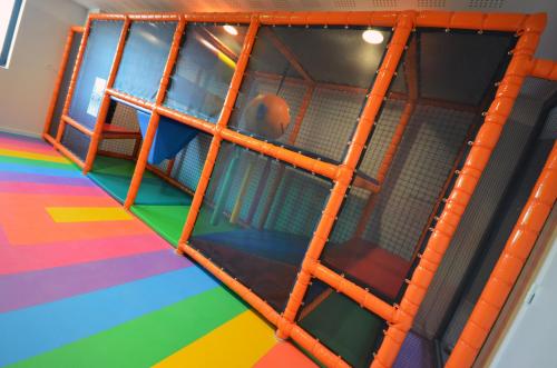 an indoor play room with an orange ladder at Holiday Inn Dijon Toison D'or by IHG in Dijon