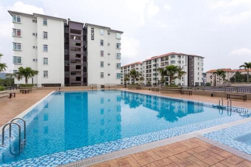 a large swimming pool in front of a building at Yuslina Homestay in Bandar Puncak Alam