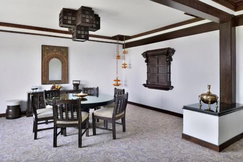 a dining room with a table and chairs at Taj Mahal, New Delhi in New Delhi