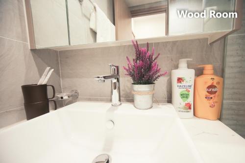 a bathroom counter with a sink and a bottle of soap at Apartment 1BR-FL22th-R103 Building-Vinhome Ocean Park in Hanoi