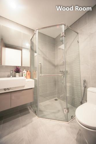 a bathroom with a shower and a toilet and a sink at Apartment 1BR-FL22th-R103 Building-Vinhome Ocean Park in Hanoi