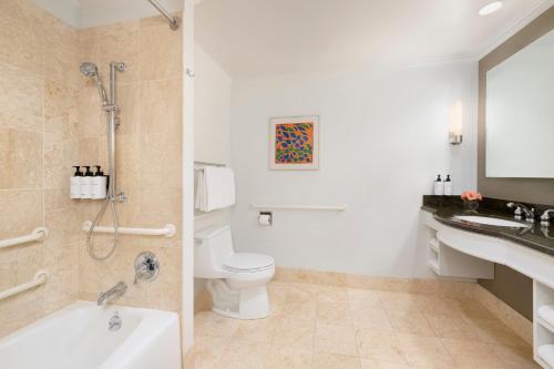 a bathroom with a tub and a toilet and a sink at InterContinental Cleveland by IHG in Cleveland
