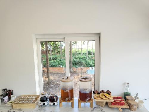 a kitchen with a table with food and a window at BB Hotel&Resort in Phu Quoc