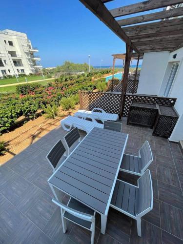 a picnic table and chairs on a patio at Great seaview appartments in Thalassa in Vokolidha