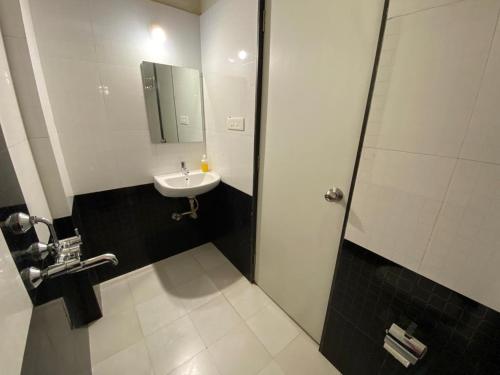 a bathroom with a sink and a shower at COSMO STAYS Venus in Pune