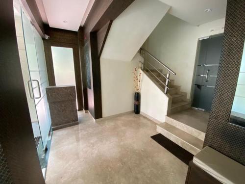 an empty hallway with stairs in a building at COSMO STAYS Venus in Pune