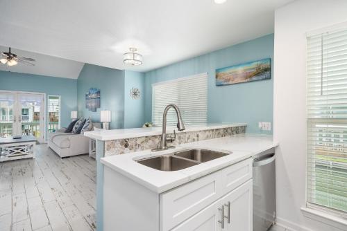 a kitchen with a sink and blue walls at Coastal Bliss in Rockport