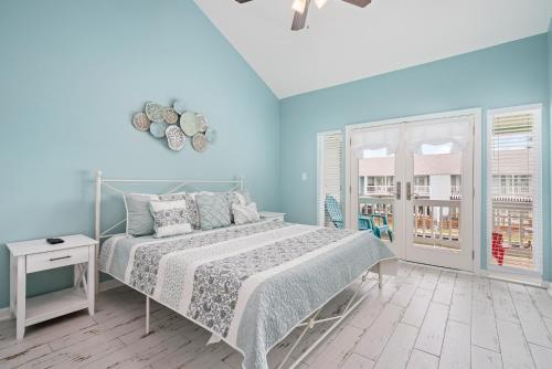 a bedroom with a bed and a blue wall at Coastal Bliss in Rockport