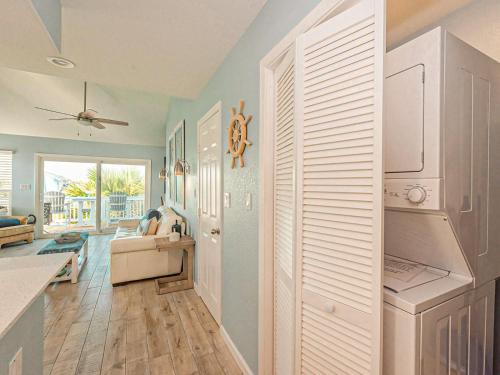 a kitchen and living room with blue walls at Kontiki Bayfront Condo 405 in Rockport