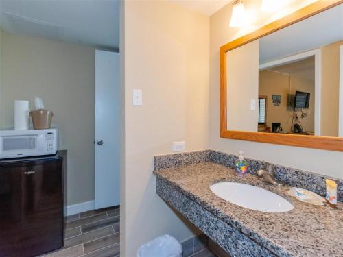 a bathroom with a sink and a mirror at LR 117 - Gone Fishing in Rockport